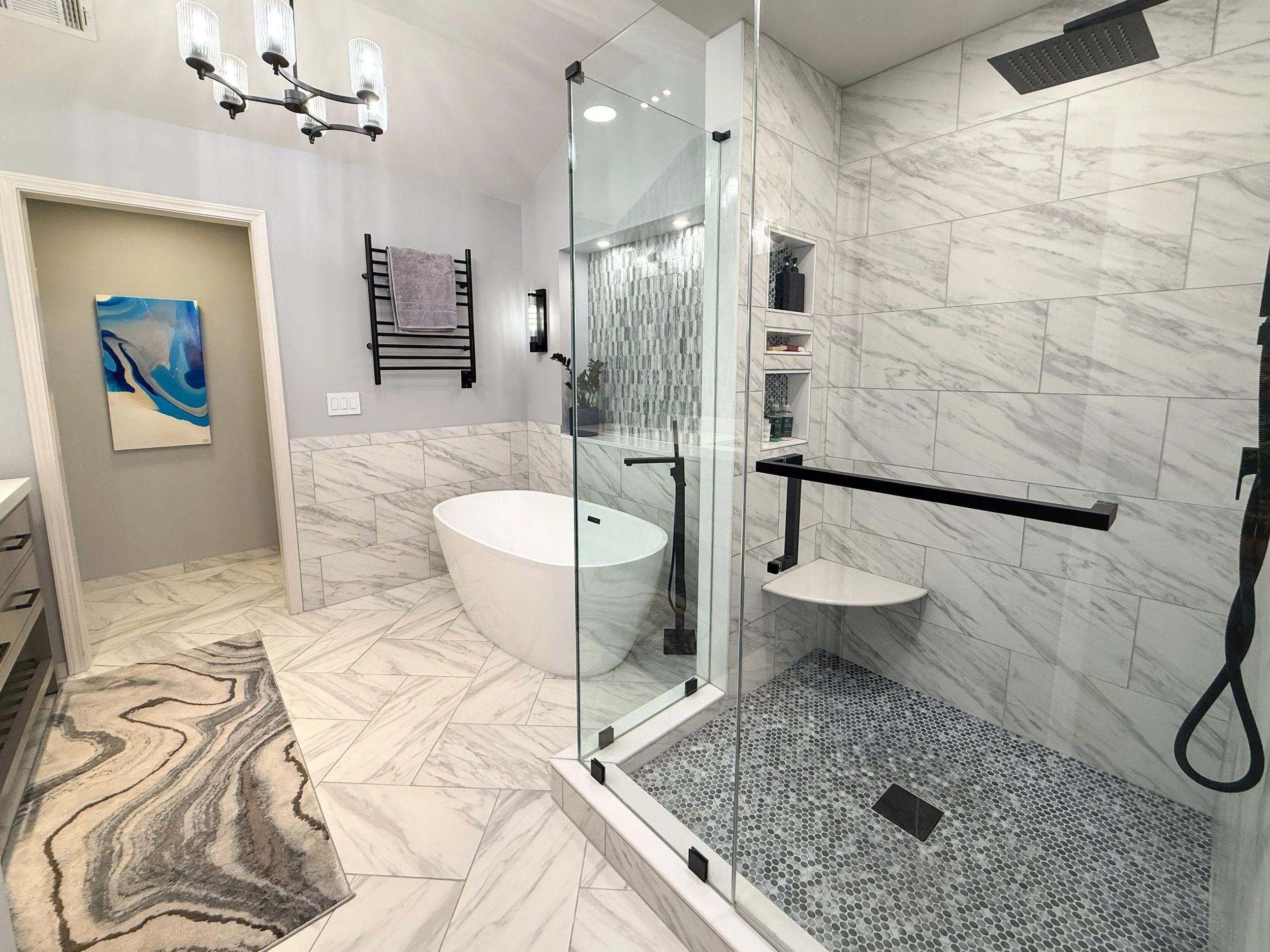Spa-like primary bath featuring a large glass shower, soaking tub, double vanity, and designer finishes throughout.