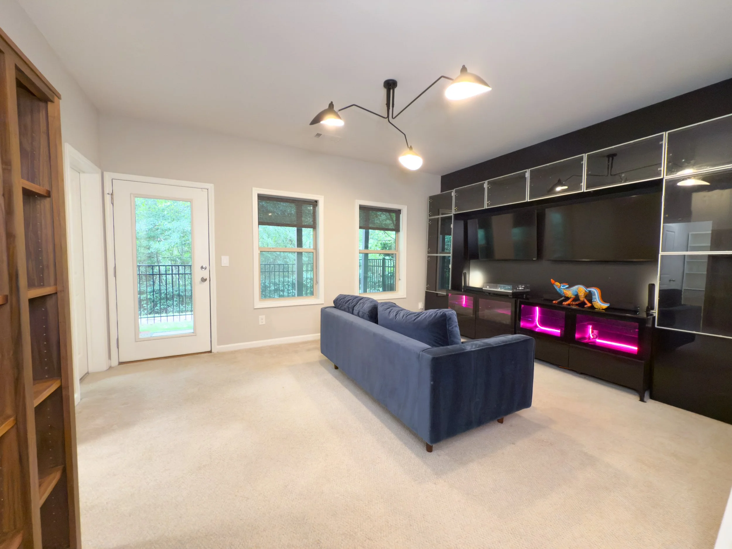 Bright lower-level room with full bath, walk-in closet, and access to patio. Use as a media room or bedroom.