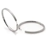 A silver-colored open hoop earring.