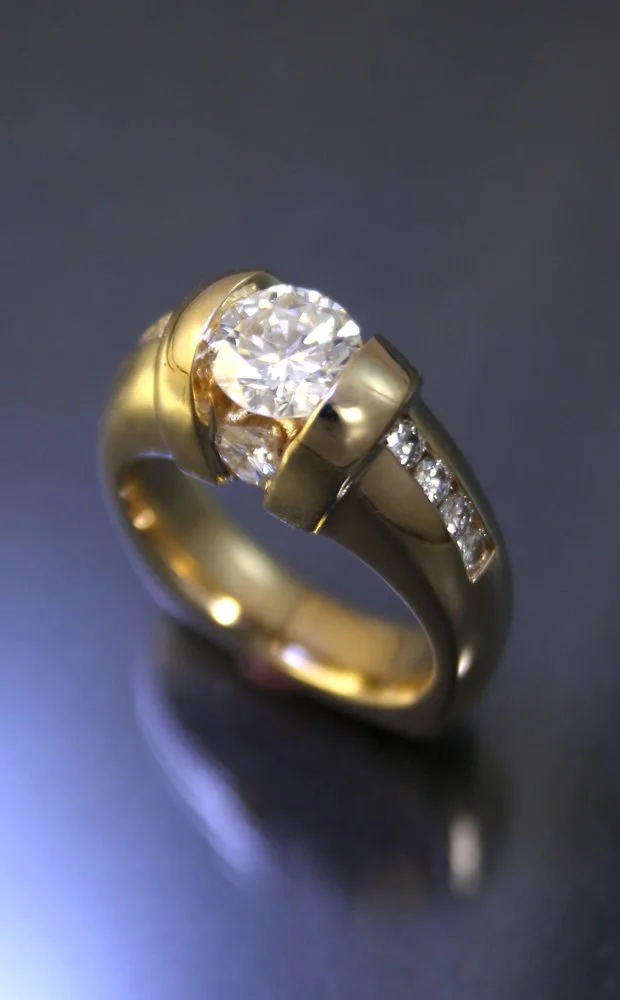 A gold ring with a large central diamond and smaller diamonds embedded along the band.