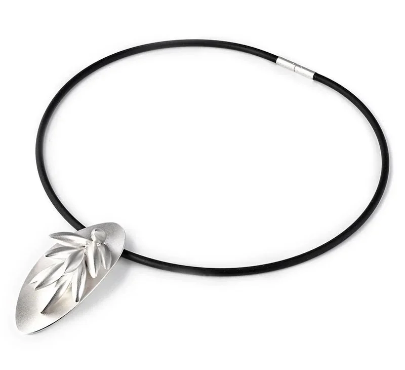 Necklace with a metallic leaf pendant on a black cord