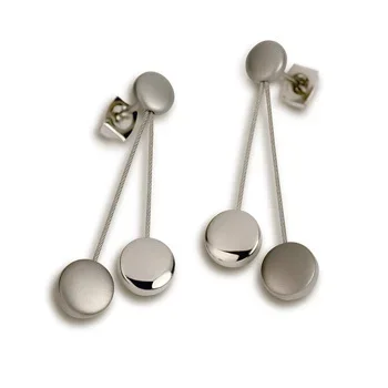 A pair of modern geometric wall hooks with ball-shaped ends, attached to a white wall.