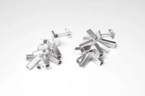 Two metallic mechanical parts with various cutouts and protrusions on a white background.