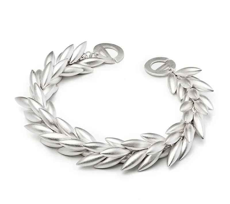 Silver bracelet with leaf-shaped links on a white background