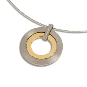 A circular pendant necklace with a gold-colored inner ring and a larger gray outer ring, hanging from a silver chain.