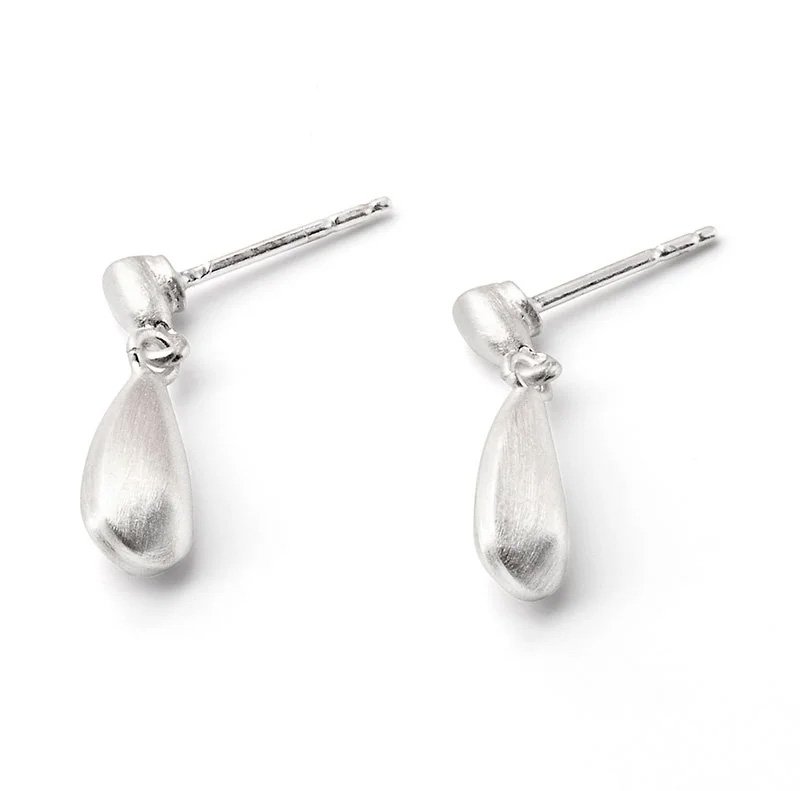 Silver teardrop-shaped stud earrings placed on a white background.