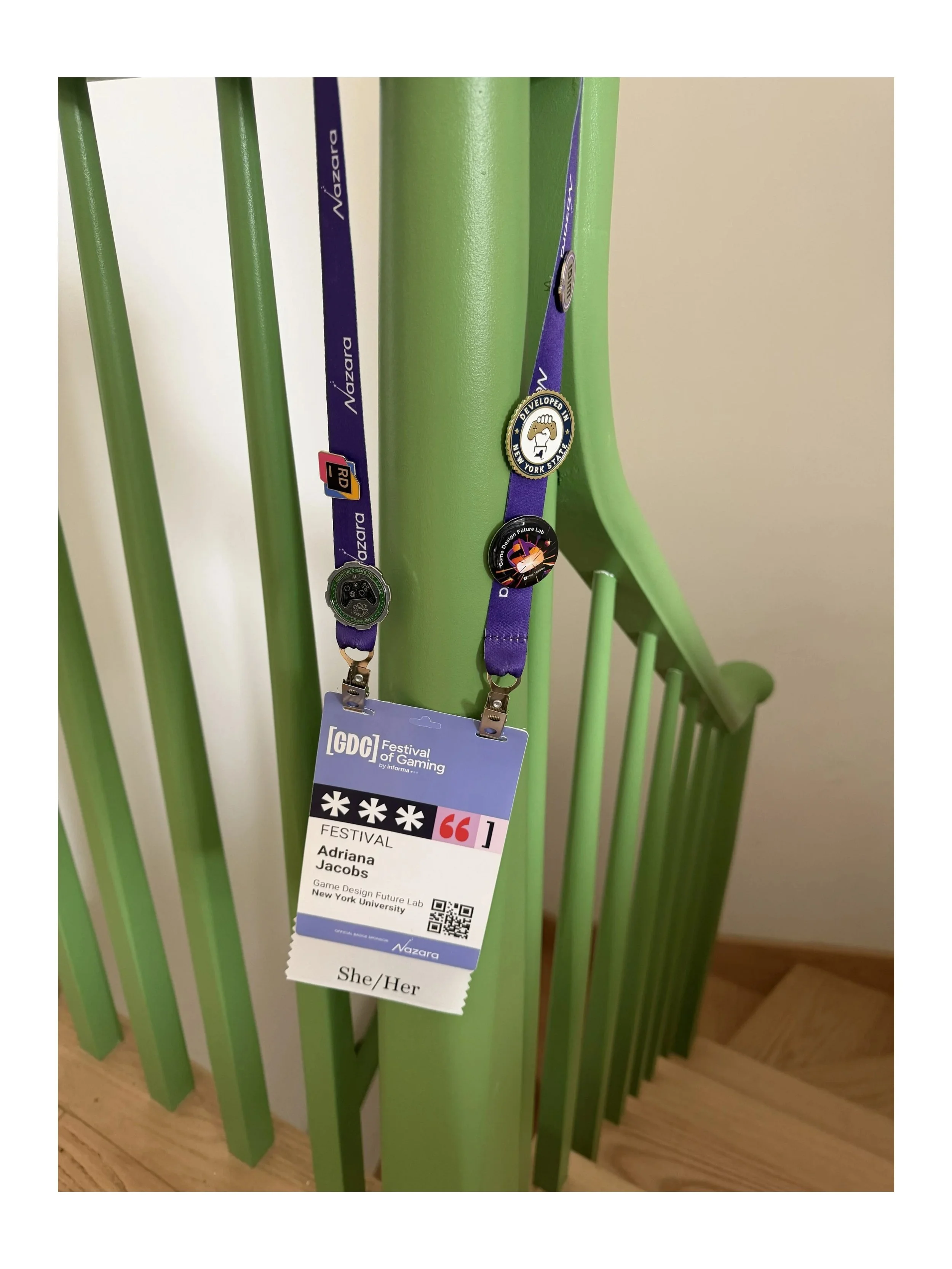 Lilac GDC badge with pins and pronouns.