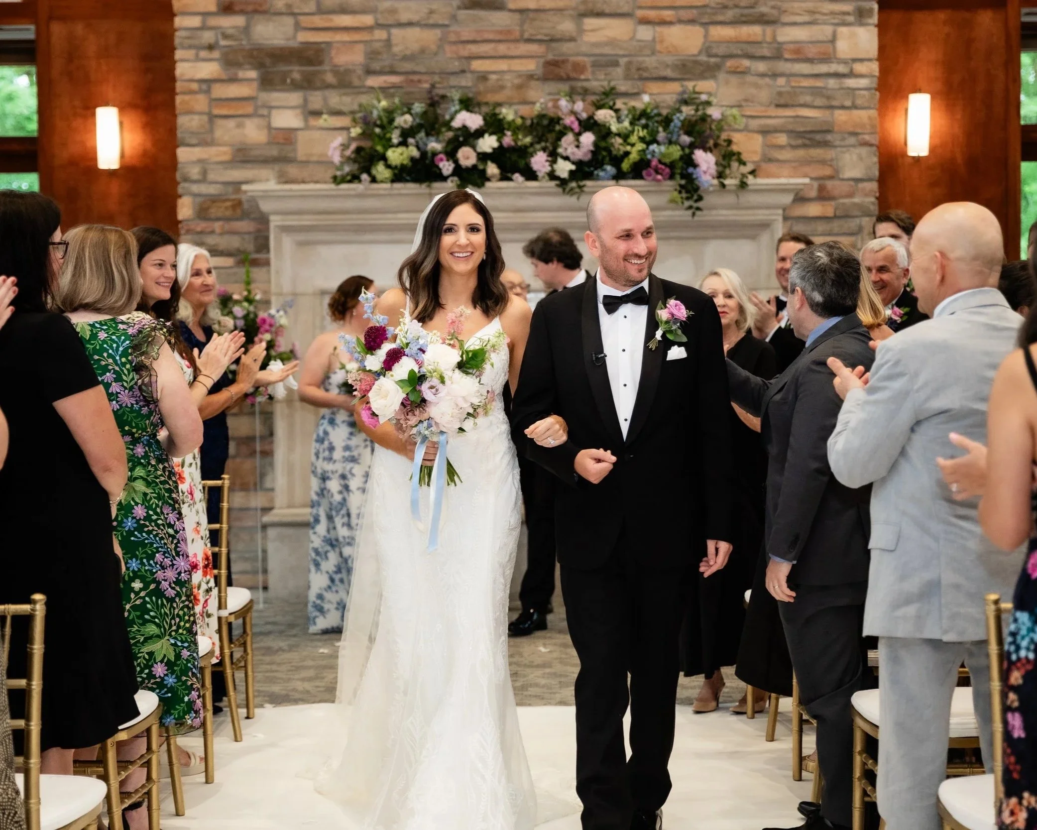 bride-and-groom-smiling-walking-down-aisle-the-woodlands-wedding