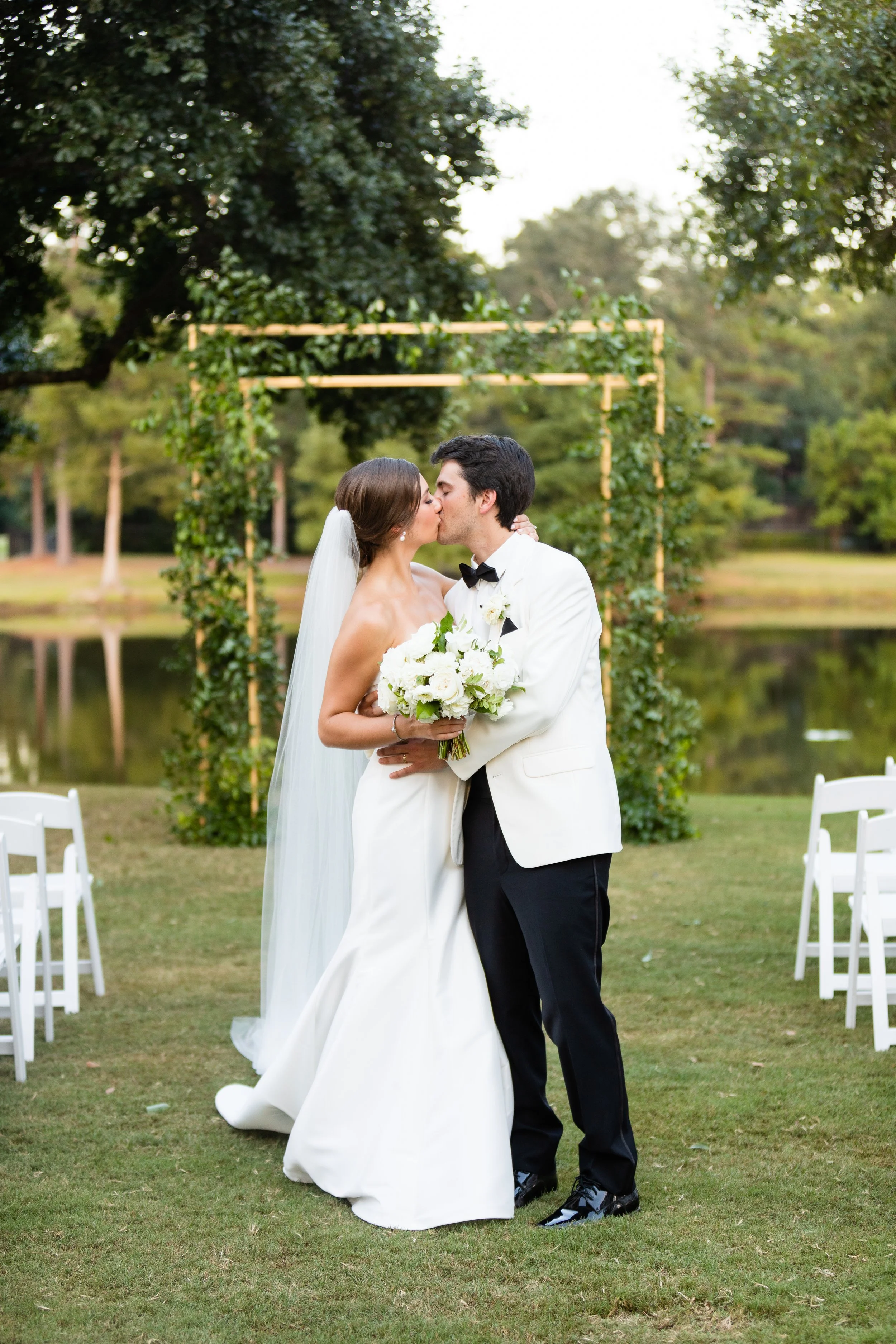 the-woodlands-country-club-bride-groom-kissing-outdoor-ceremony