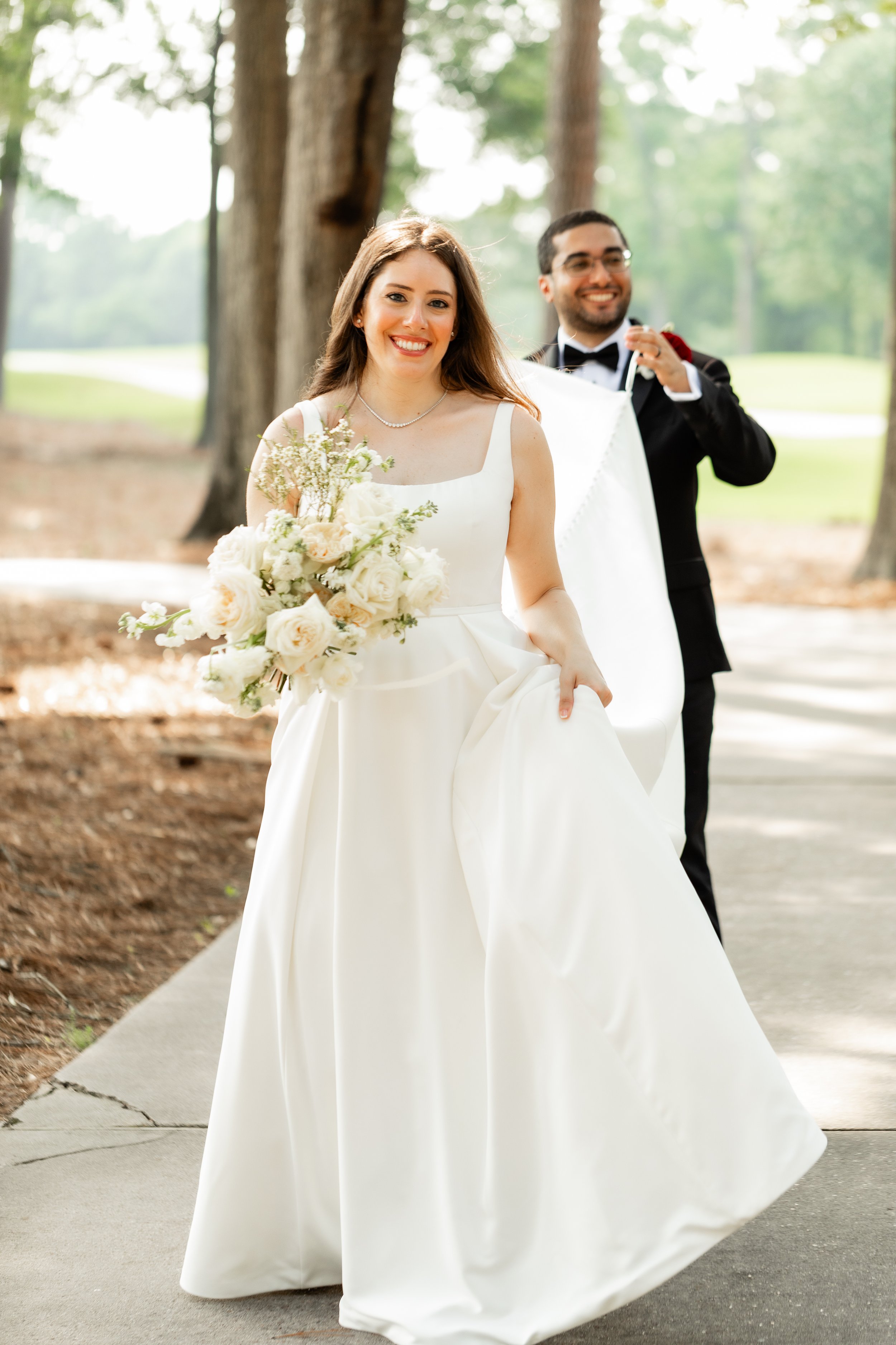 groom-helping-bride-carry-dress-the-woodlands-wedding-photos