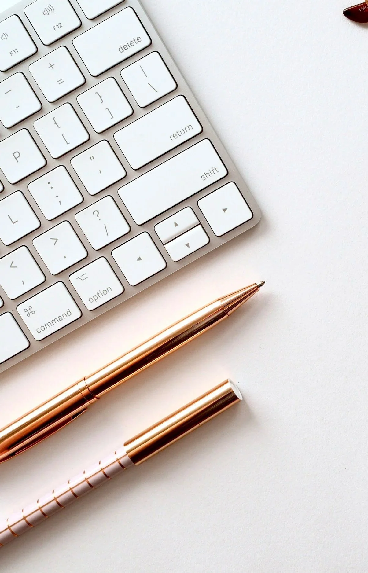 A keyboard and pens illustrate digital services at Guided Bloom Marketing.