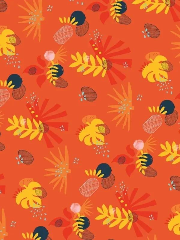 Close-up of tropical pattern showing scattered leaves, geometric red and yellow shapes, and indigo speckles on orange-red background.