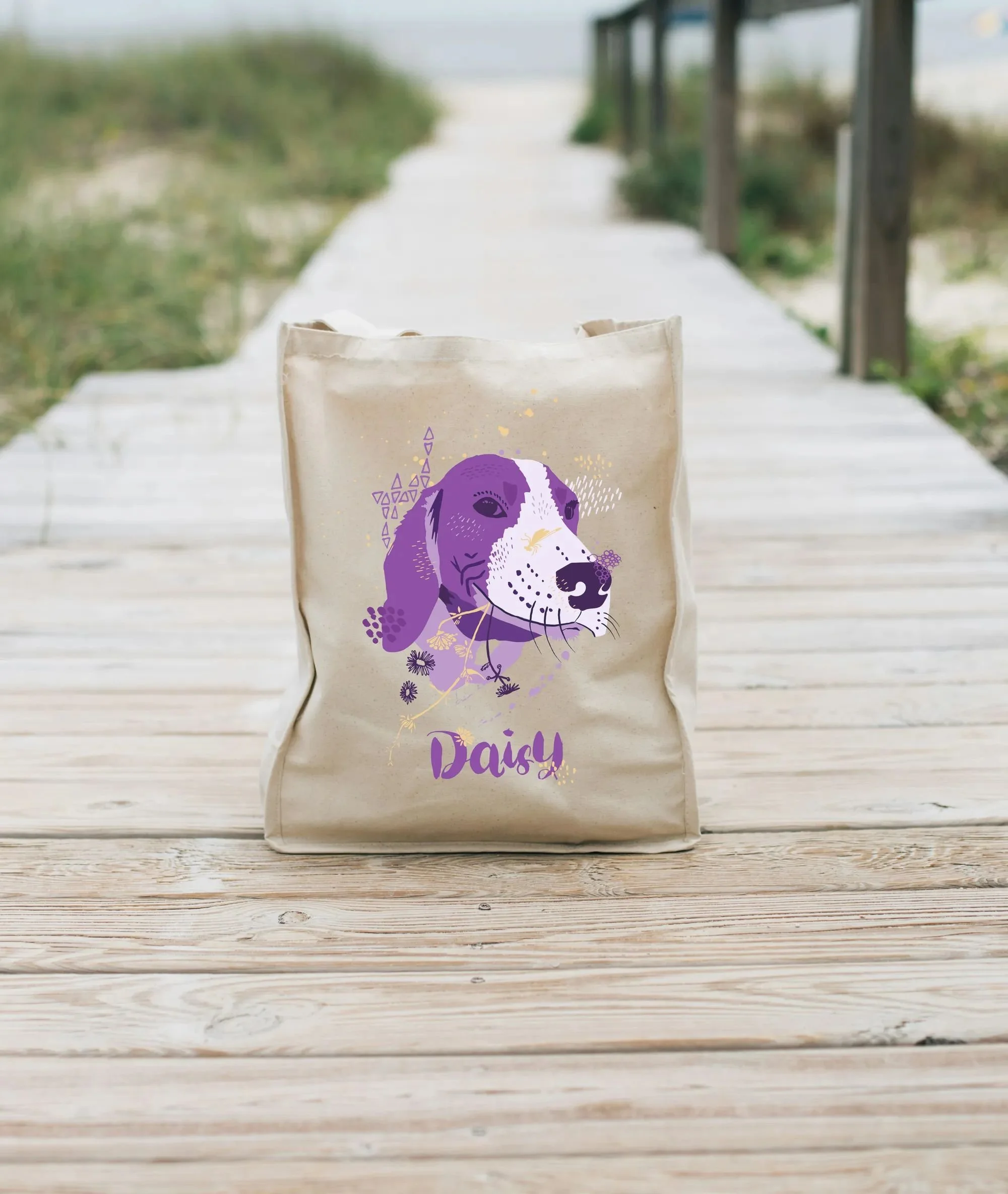 Tote bag with flat-style illustration of a beagle in violet and gold tones, in natural light.