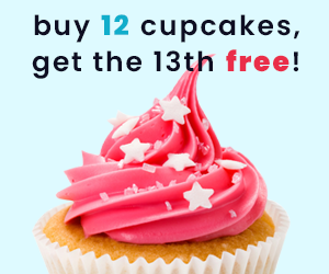 A cupcake with pink frosting decorated with white star-shaped sprinkles and a cherry on top.