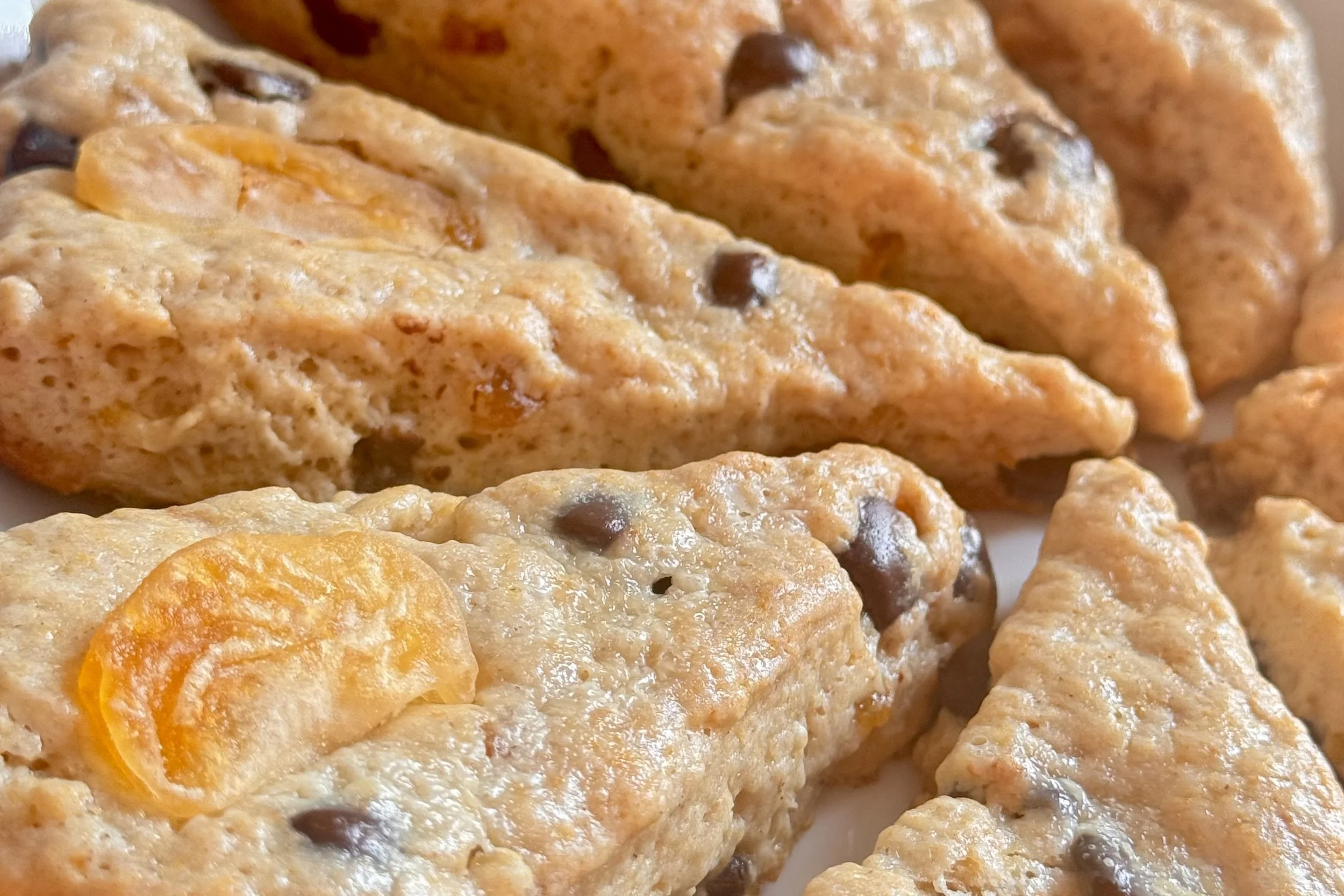 Close-up of freshly baked scones with dark chocolate and bold orange flavor.