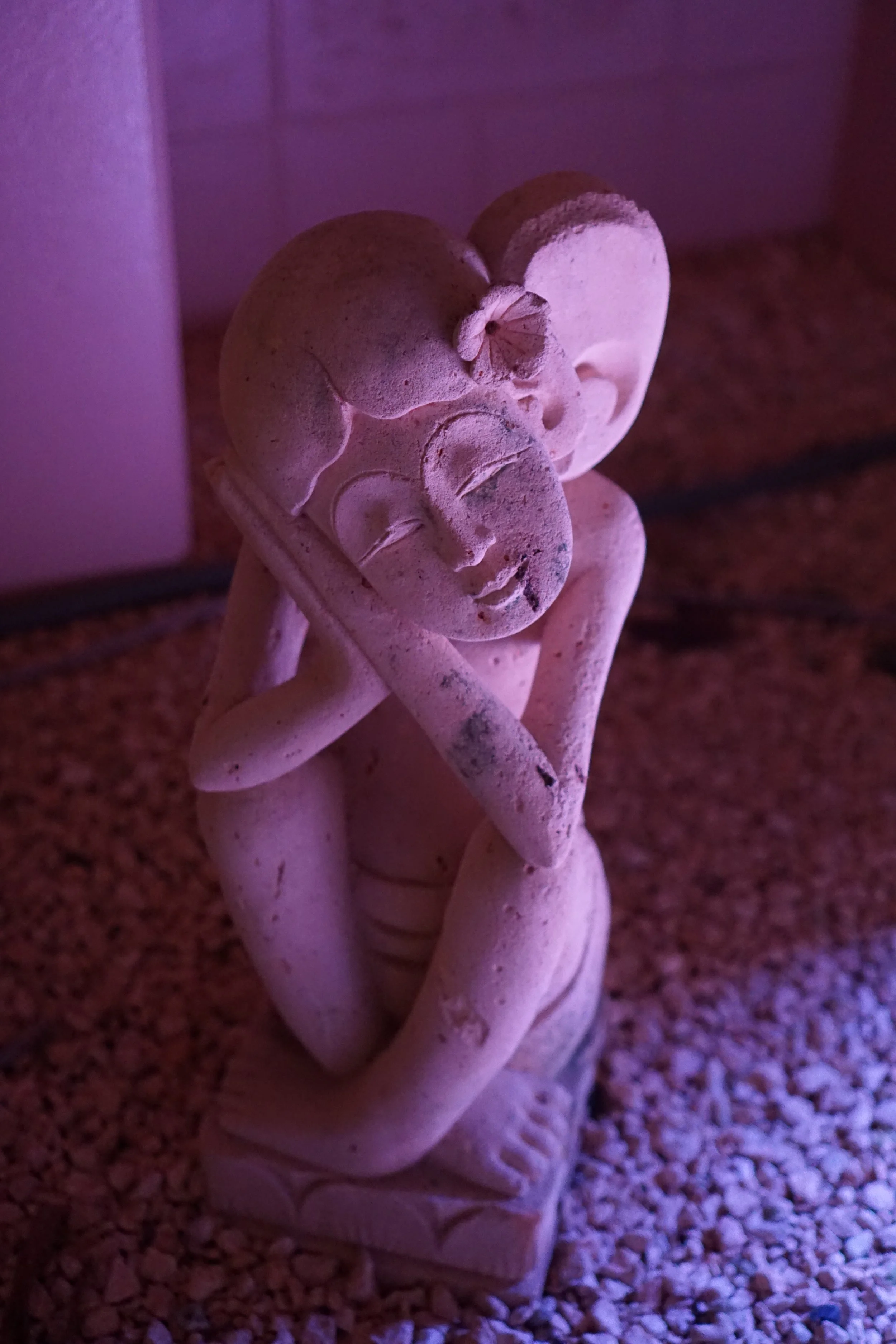 Very purple photo of an angel statue in thought or prayer in Miyakojima