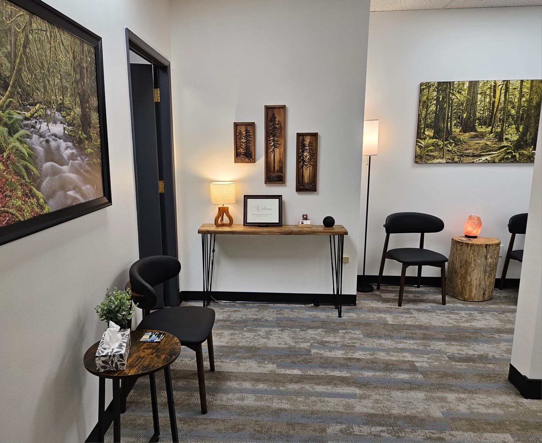 Waiting room with chairs and console table.