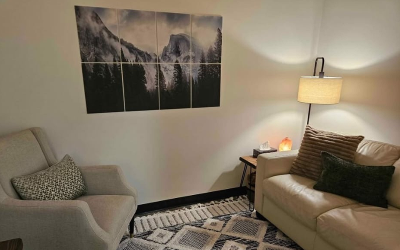 Office with cream chair and cream loveseat.