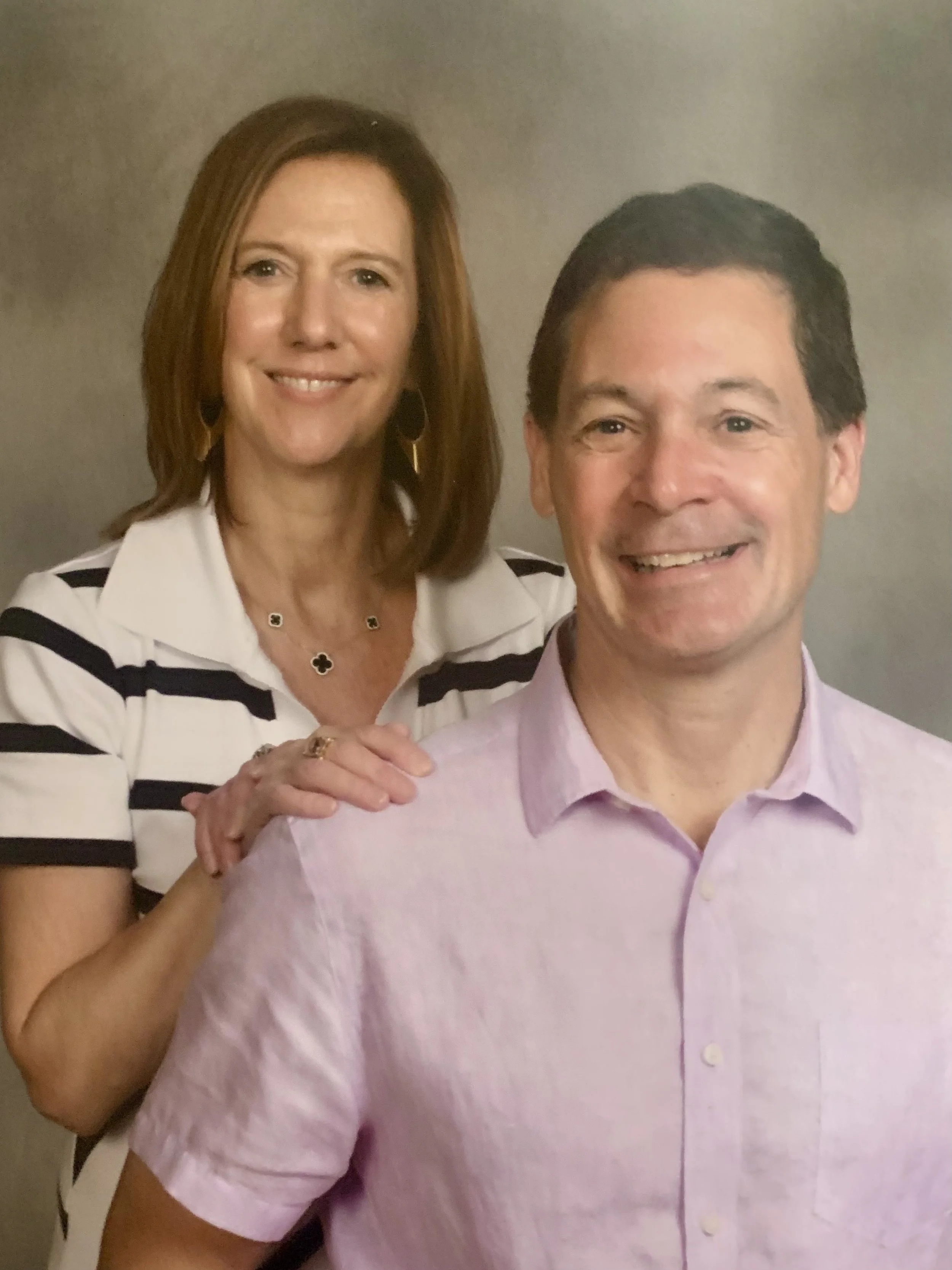 Blue background with a white chalk-like drawing of a school building surrounded by rays, and text that reads 'One Classroom Coming Soon'.