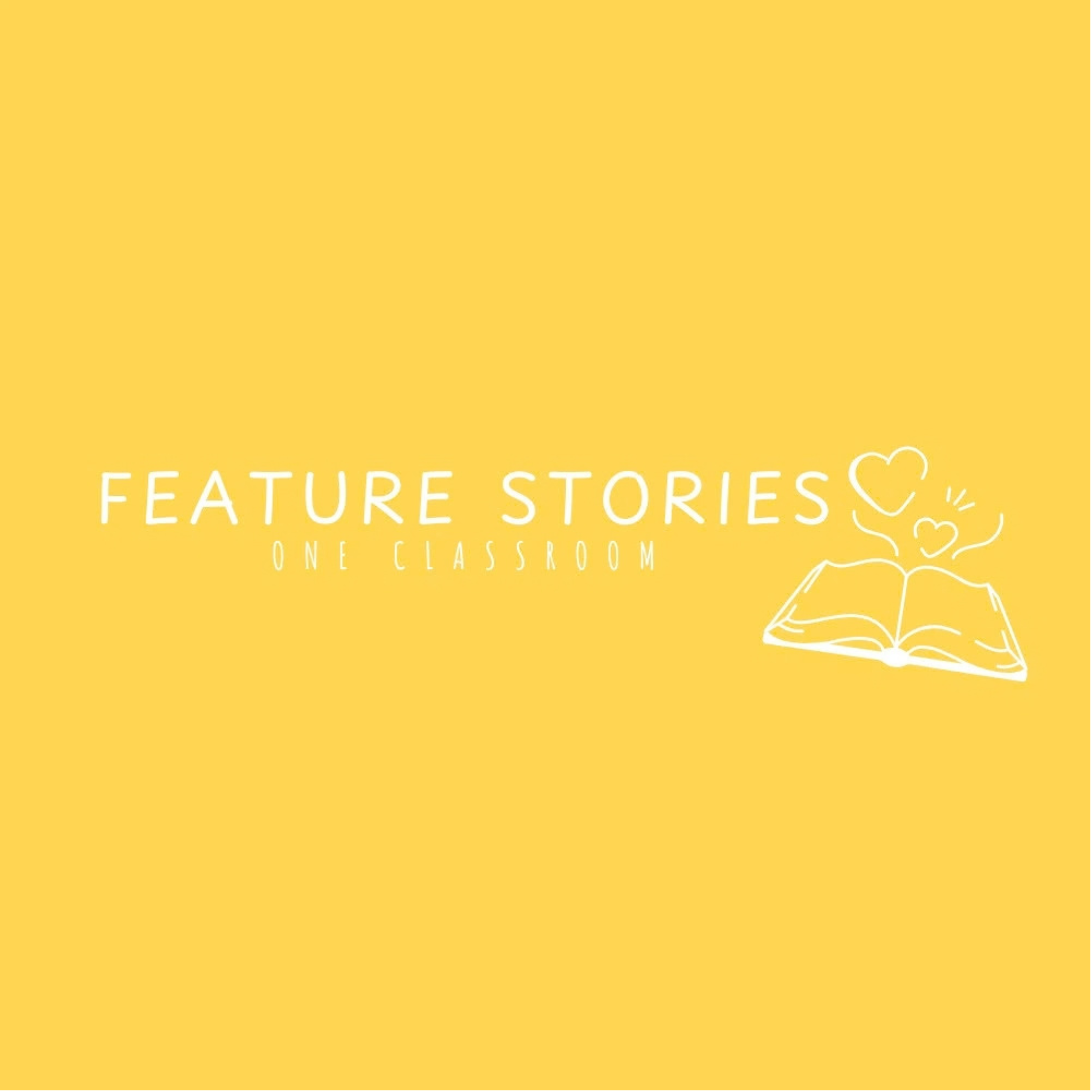 Yellow classroom sign with white text that reads 'FEATURE STORIES ONE CLASSROOM' and an open book illustration with hearts and lines.