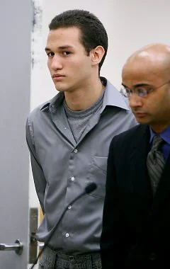 Two men in formal attire standing side by side in an indoor setting.