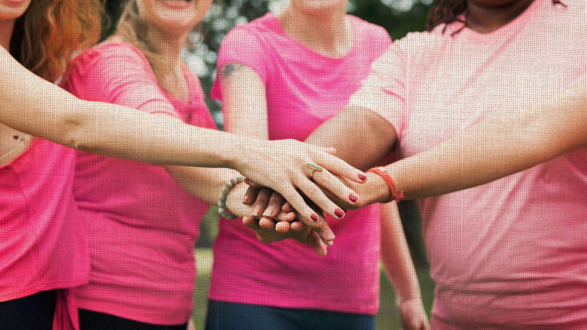 Women standing together in a group, hand in hand, in solidarity