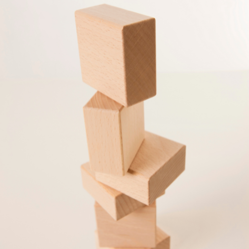Stack of five wooden blocks arranged vertically.