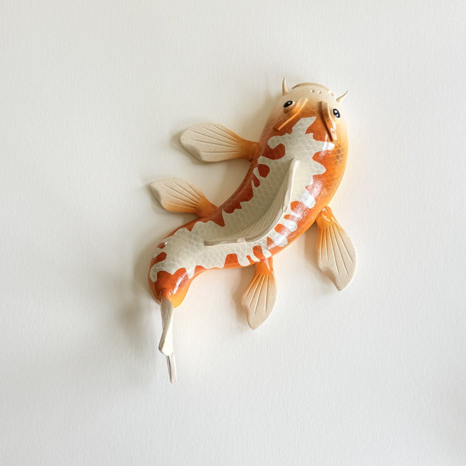 Black and orange spotted ceramic Koi wall art — sway concepts
