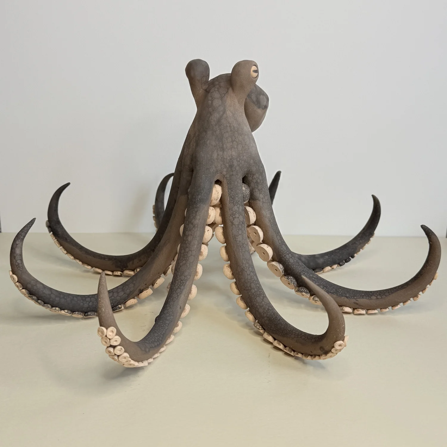 Hand-made matte brown ceramic octopus sculpture with over 240 hand