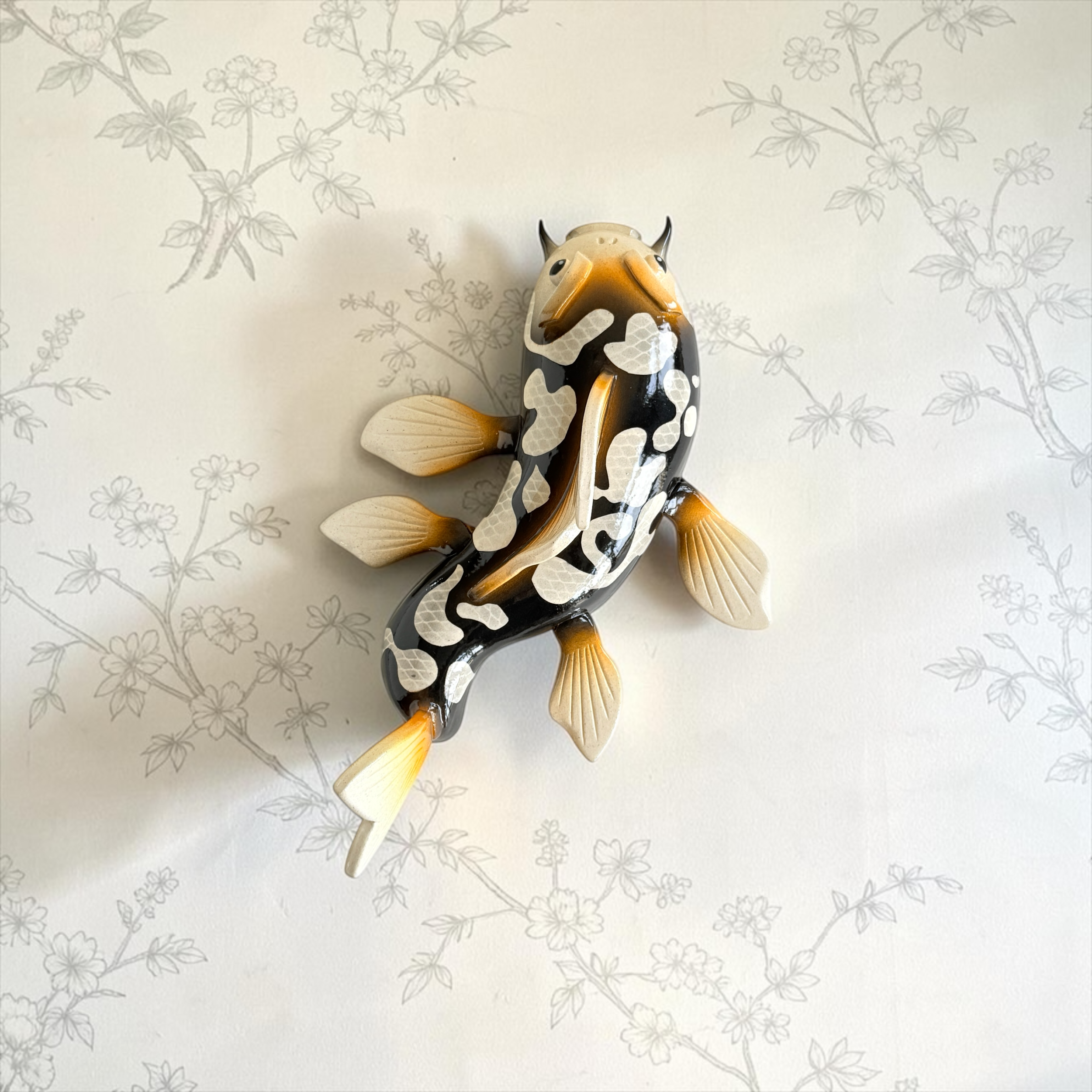 Black and gold Koi with white spots