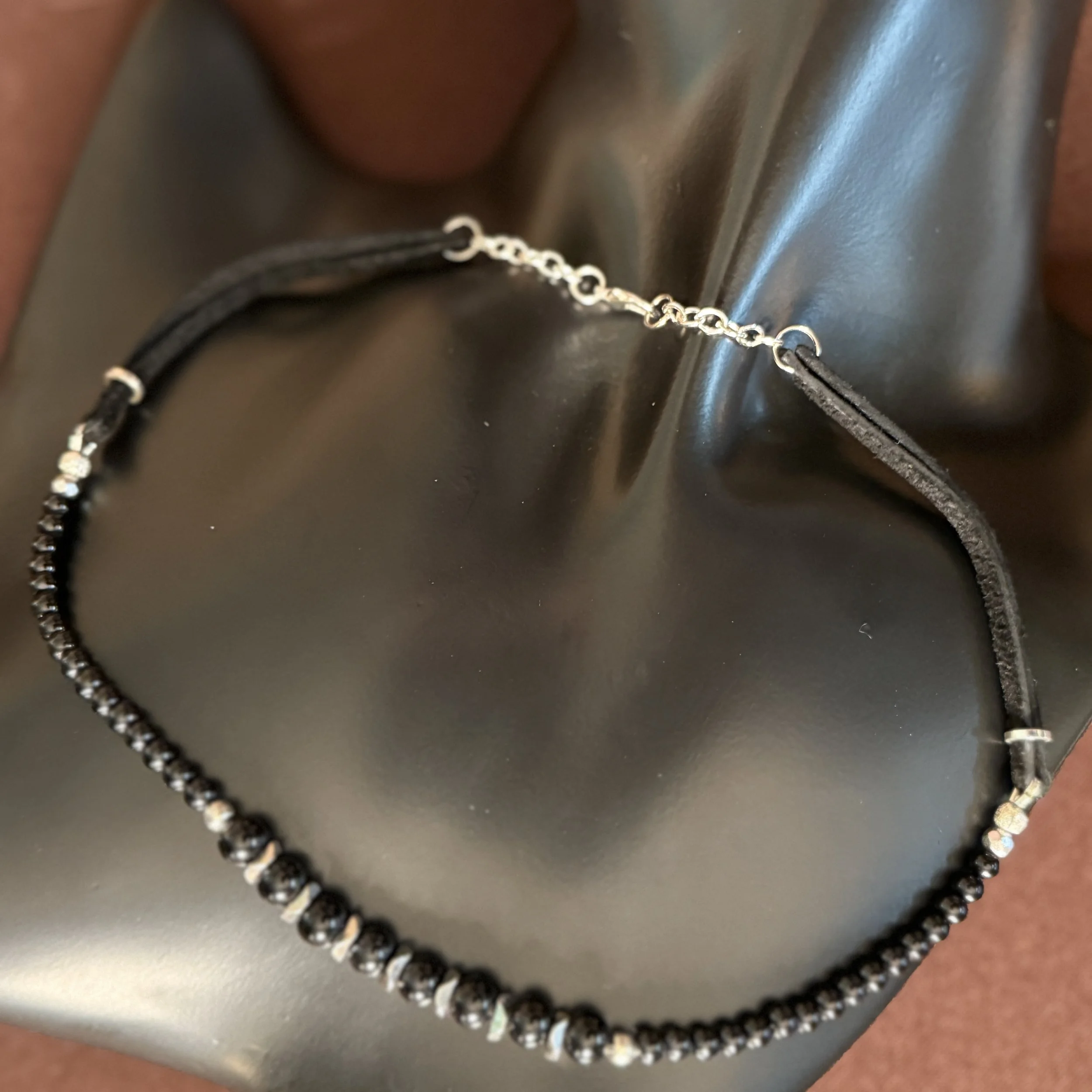 Black and silver with leather necklace.