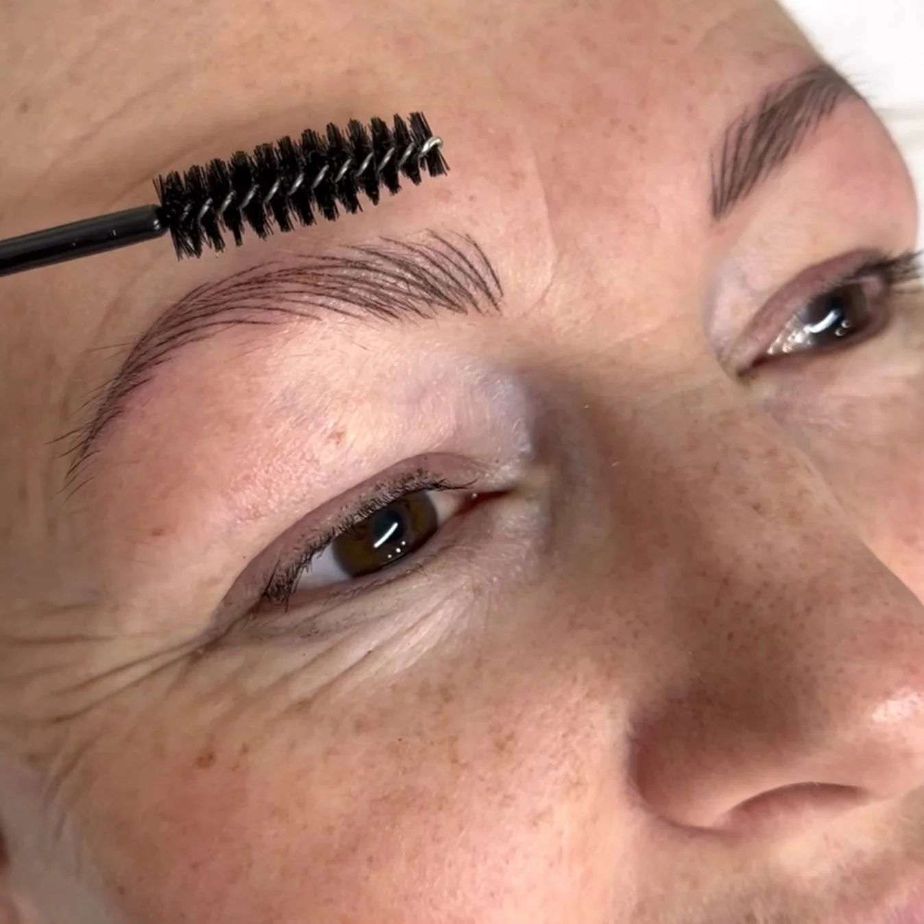 Detailed close-up of precise, fine, crisp hairstroke nano brows immediately after a session