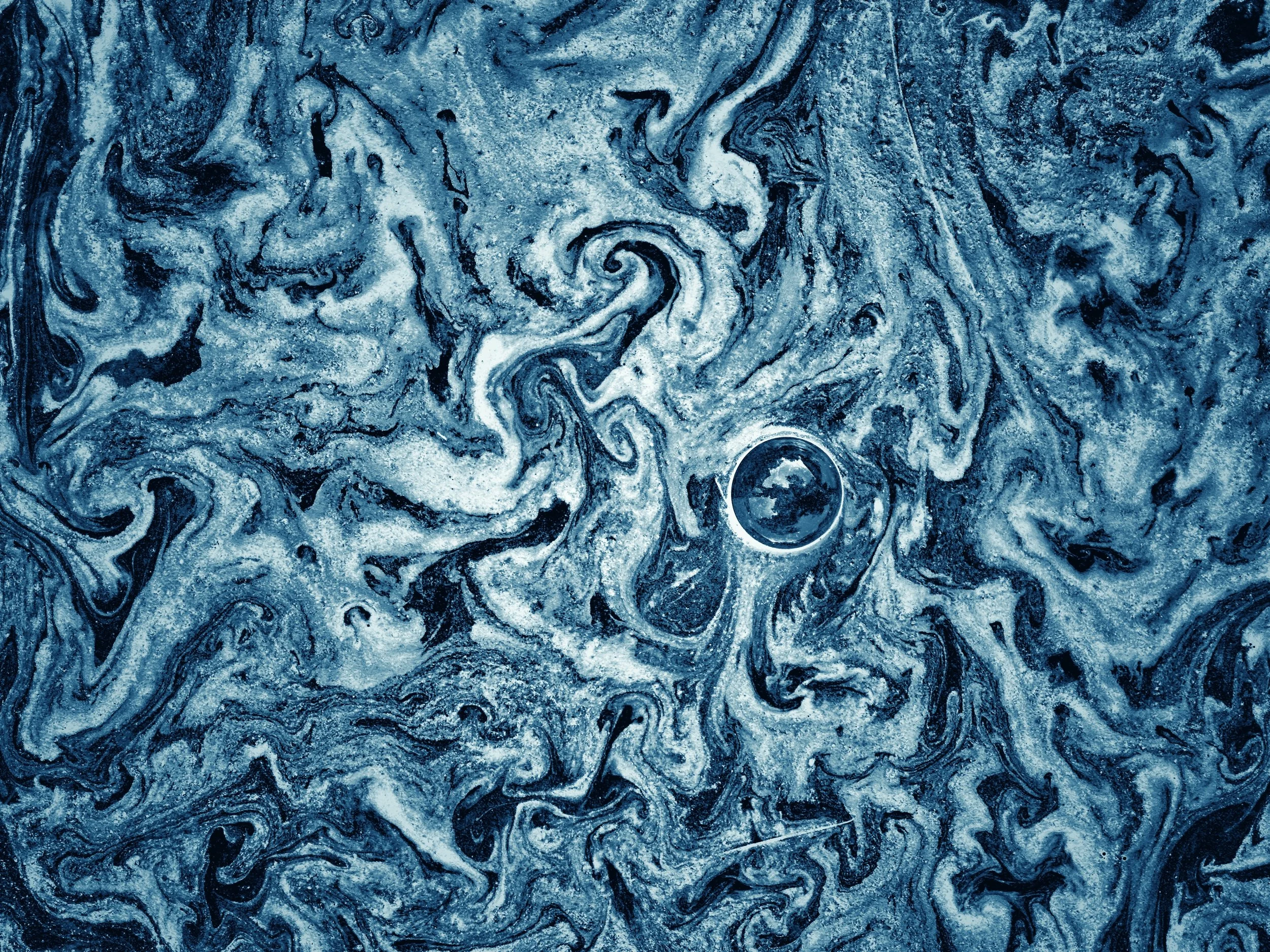 PINE POLLEN BLUES -- West Newbury, MA (June 9, 2024) -- After a rainy week in June, a dog named Molly ran through the thick layer of tree pollen floating in a puddle at the corner of our driveway, and inadvertently created swirling, strangely beautif