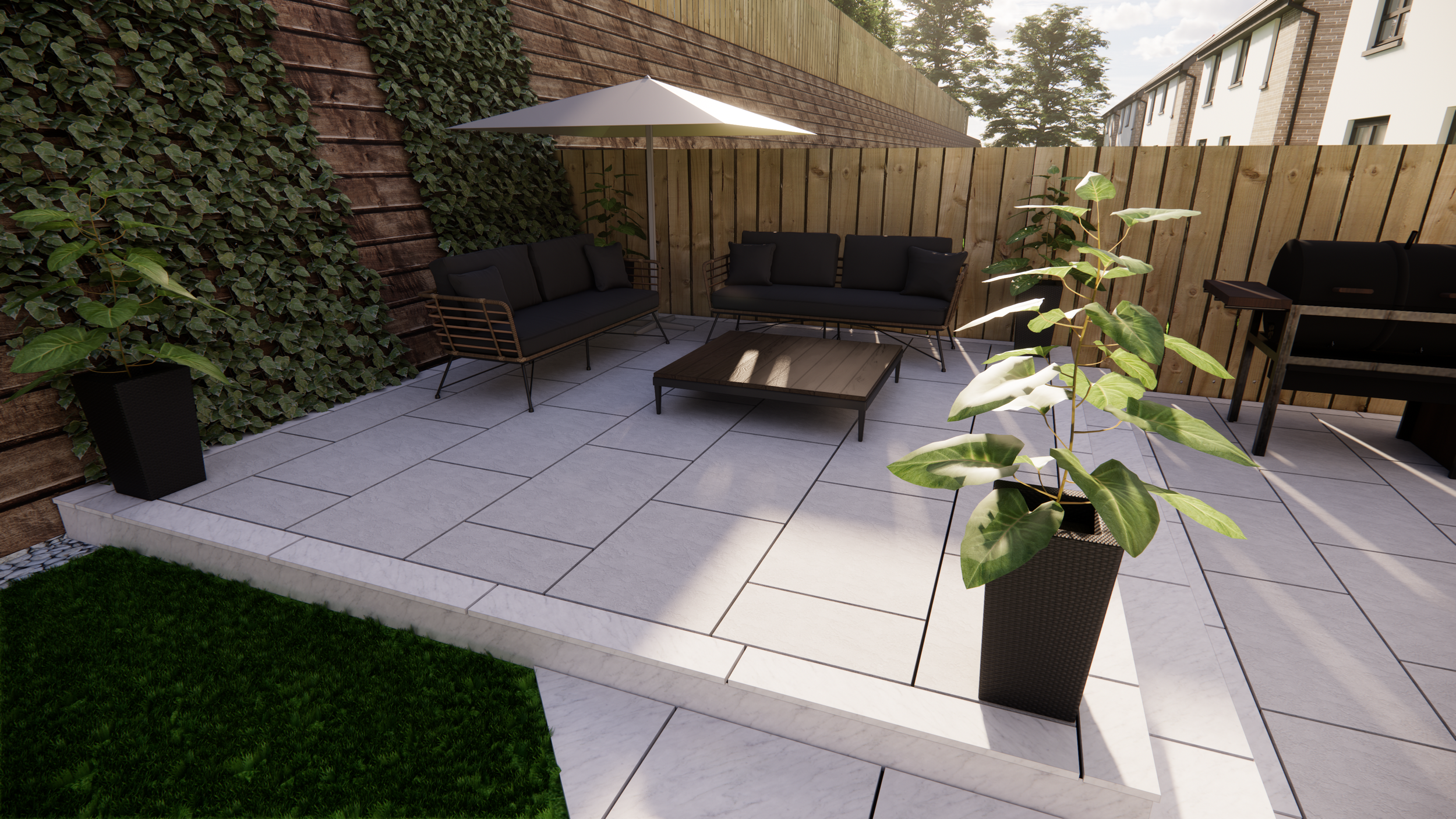 Outdoor patio with black cushioned seating, low coffee table, potted plants, umbrella, and a wood fence.