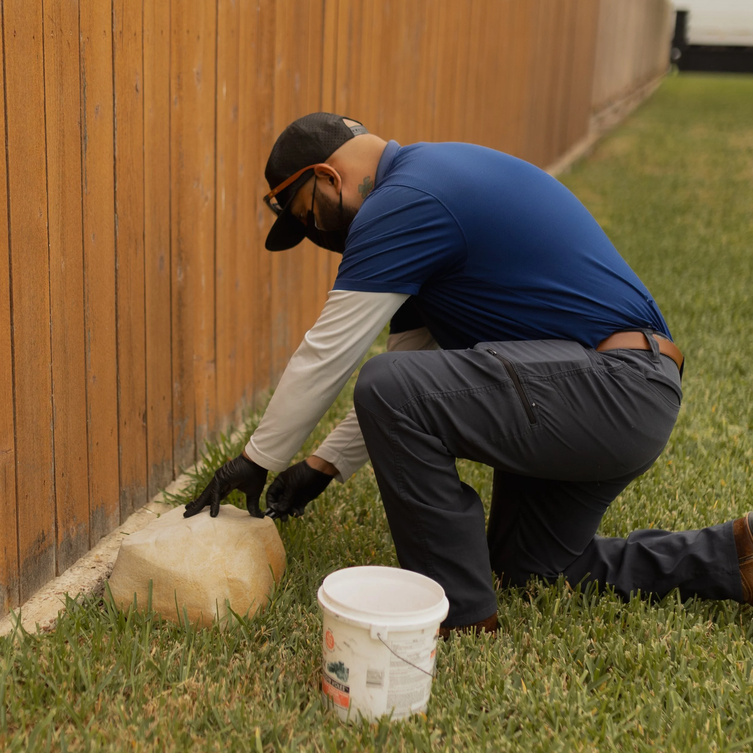 Technician checking yard for pests