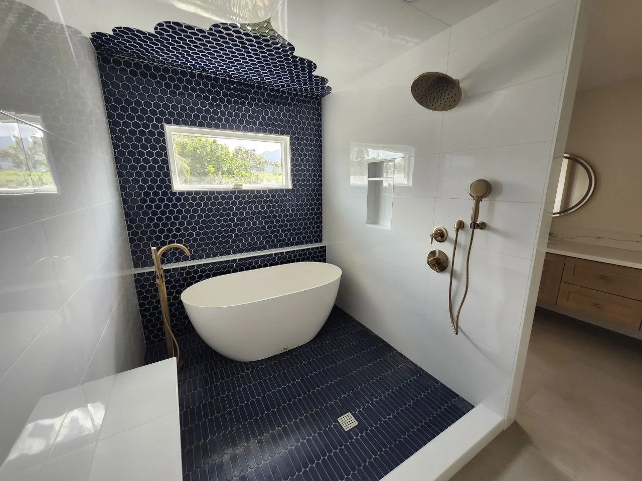 Kitchen with wooden cabinets, granite countertops, a central granite island, stainless steel range hood, built-in wine fridge, and hardwood floors.