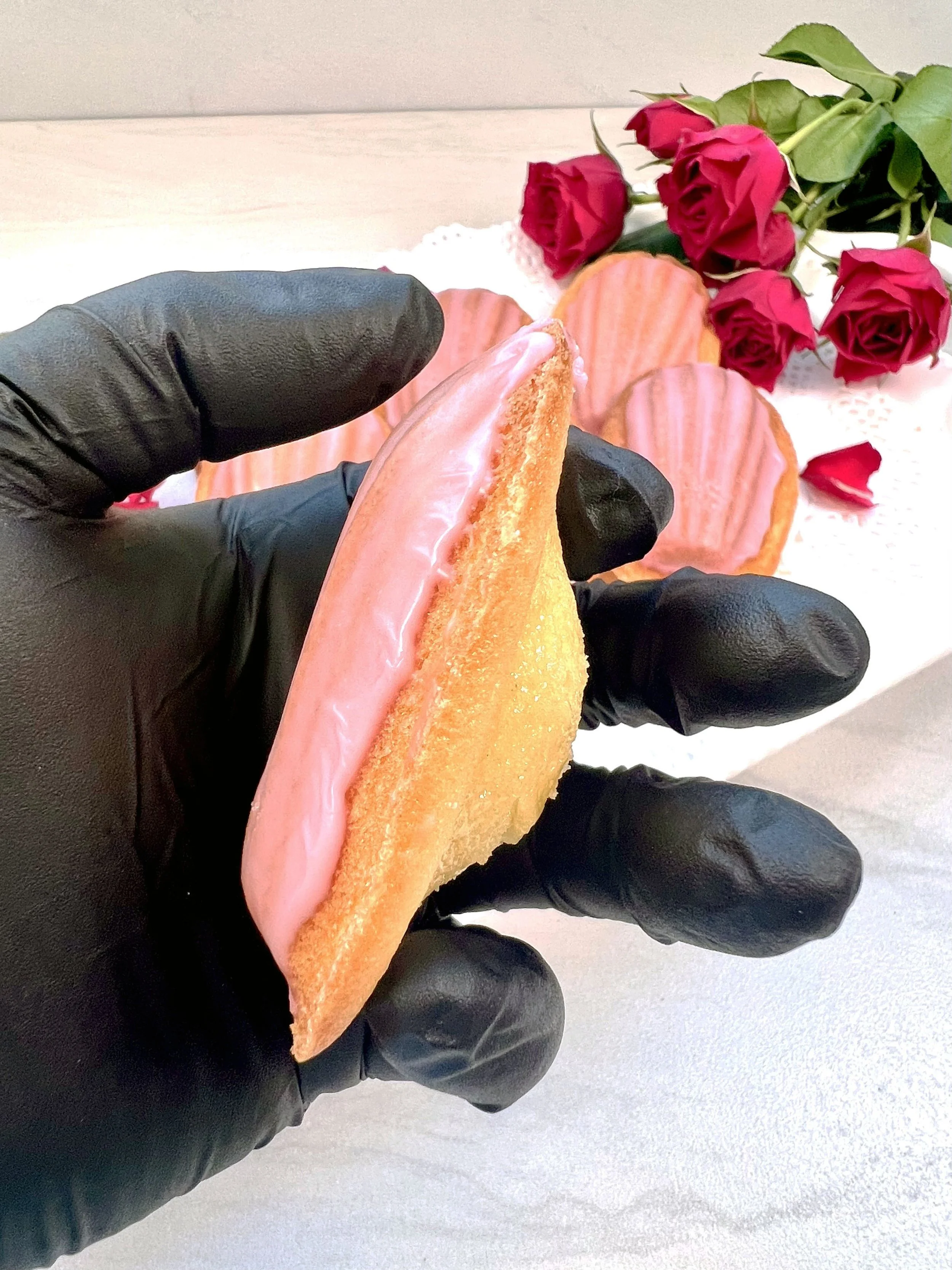 Valentine's Day Treat Box_Rose Madeleines_Gloved hand holding madeleine_side view.jpg (Copy)