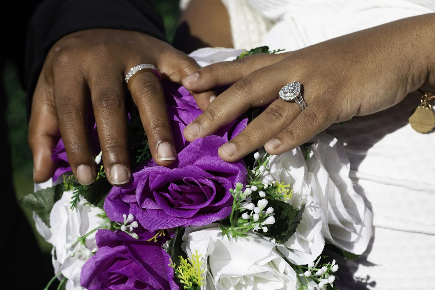 wedding-rings-hands-detail-purple-flowers.jpg