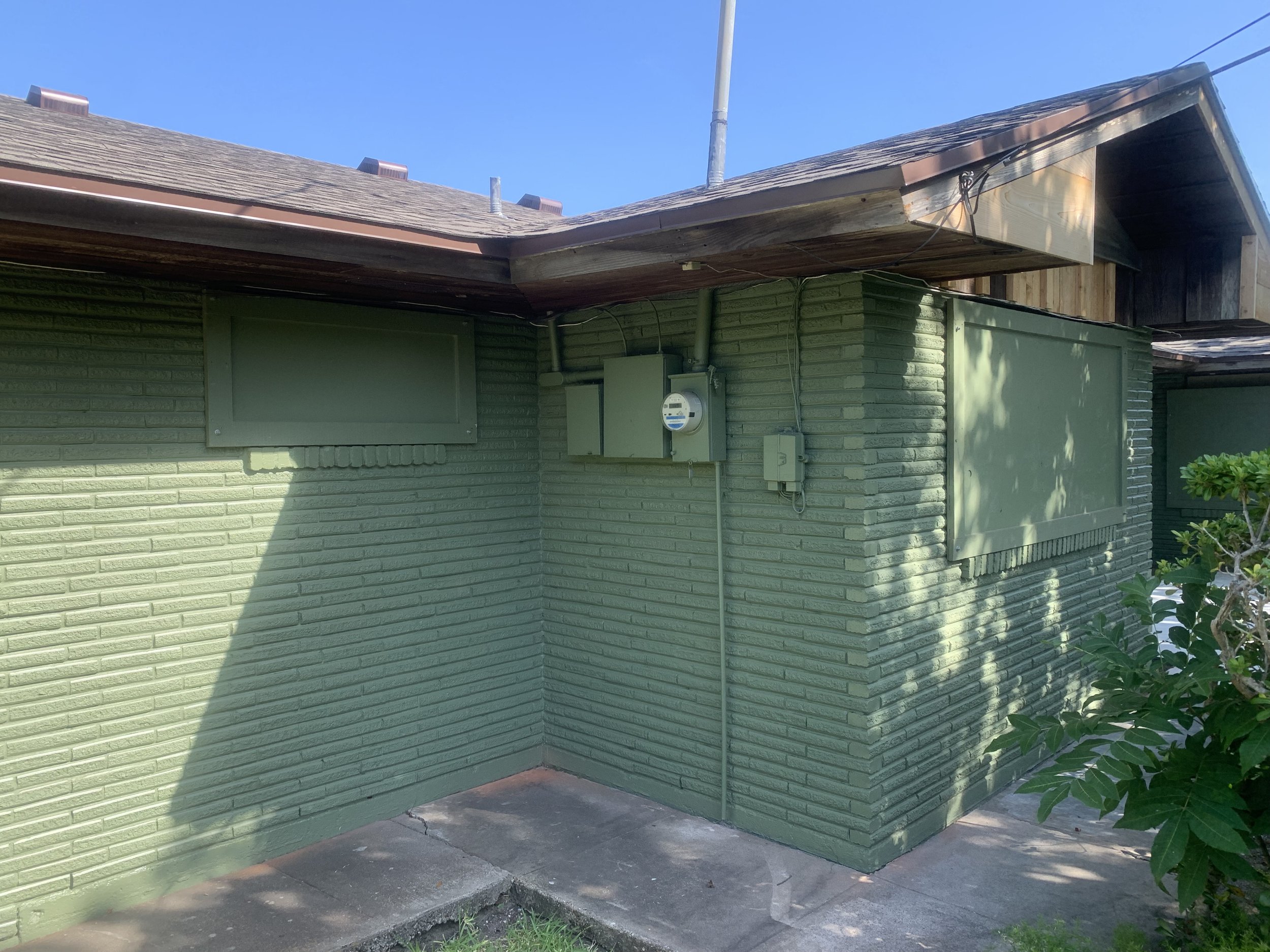 Finished storm panels installed flush over windows—blending seamlessly with the façade.