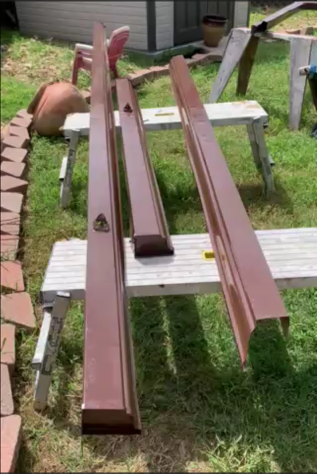 Painted gutters ready for installation.