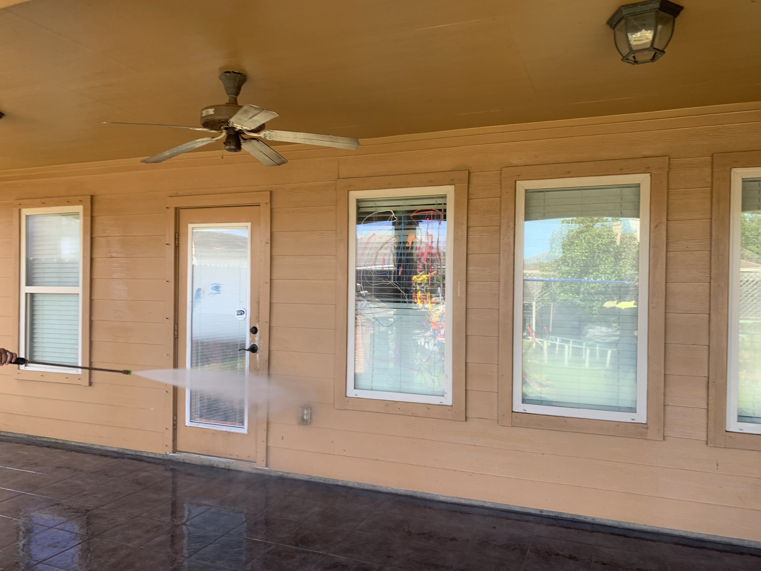 Back patio and walls power-washed to a showroom shine.