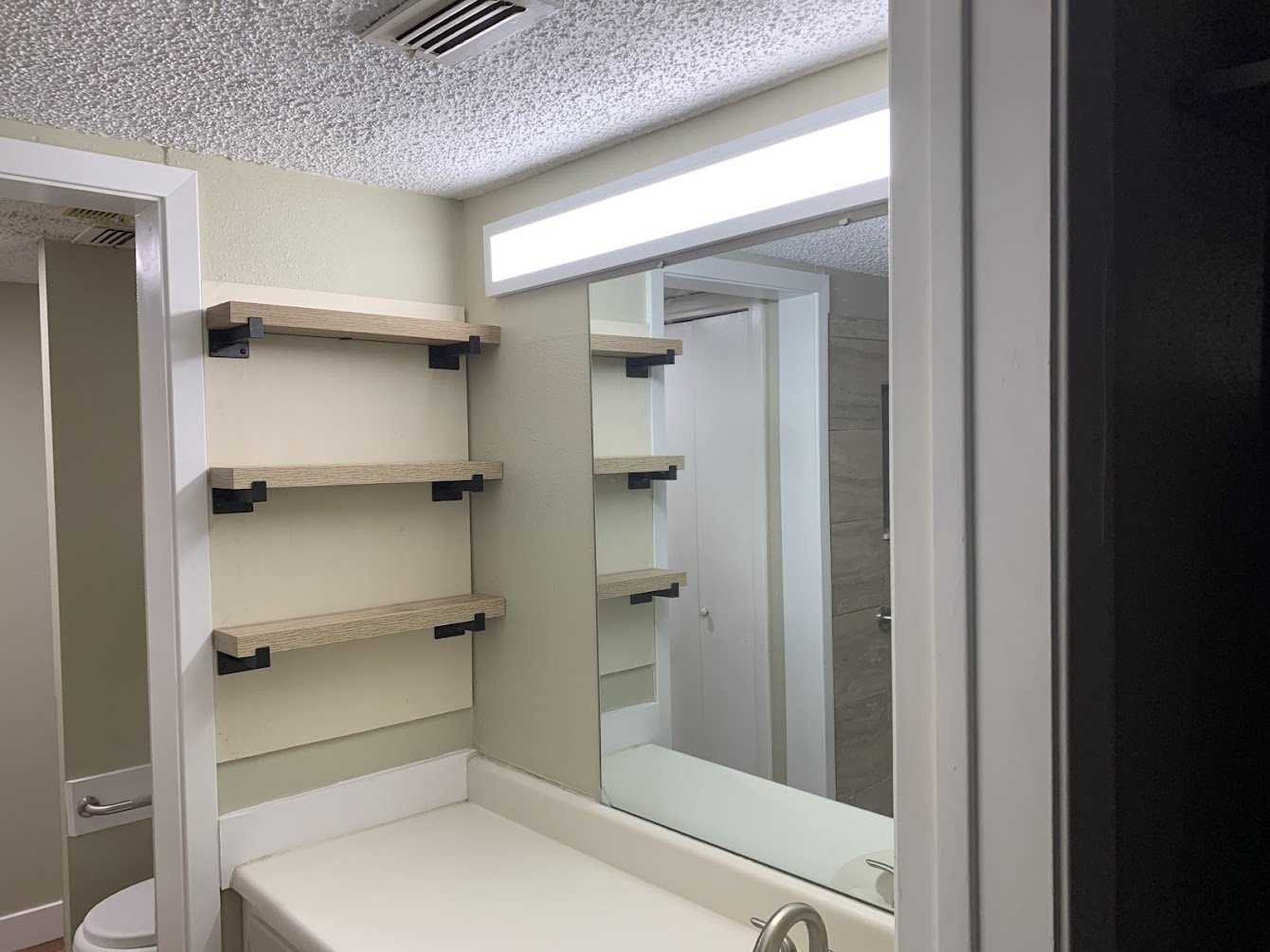 Floating Shelves & Fresh Paint on this Barrier-Free Bathroom