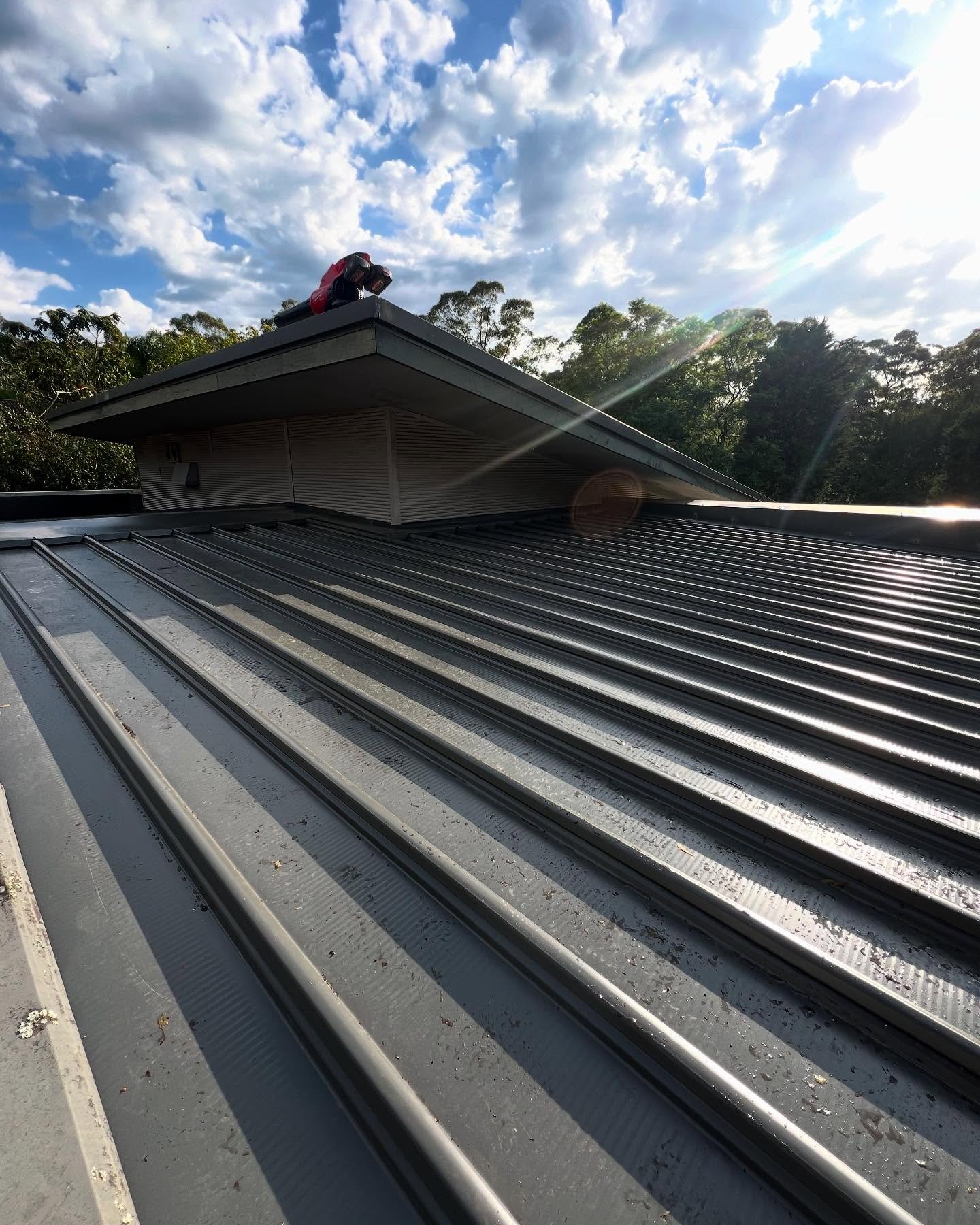 New compliant box gutter for this house in Wahroonga. Opening up the wall to allow the gutter to flow freely into a rain head at the end. 

New KlipLok700 roof sheeting from @lysaght_australia 

All custom flashings and box gutter from @no1roofing 

