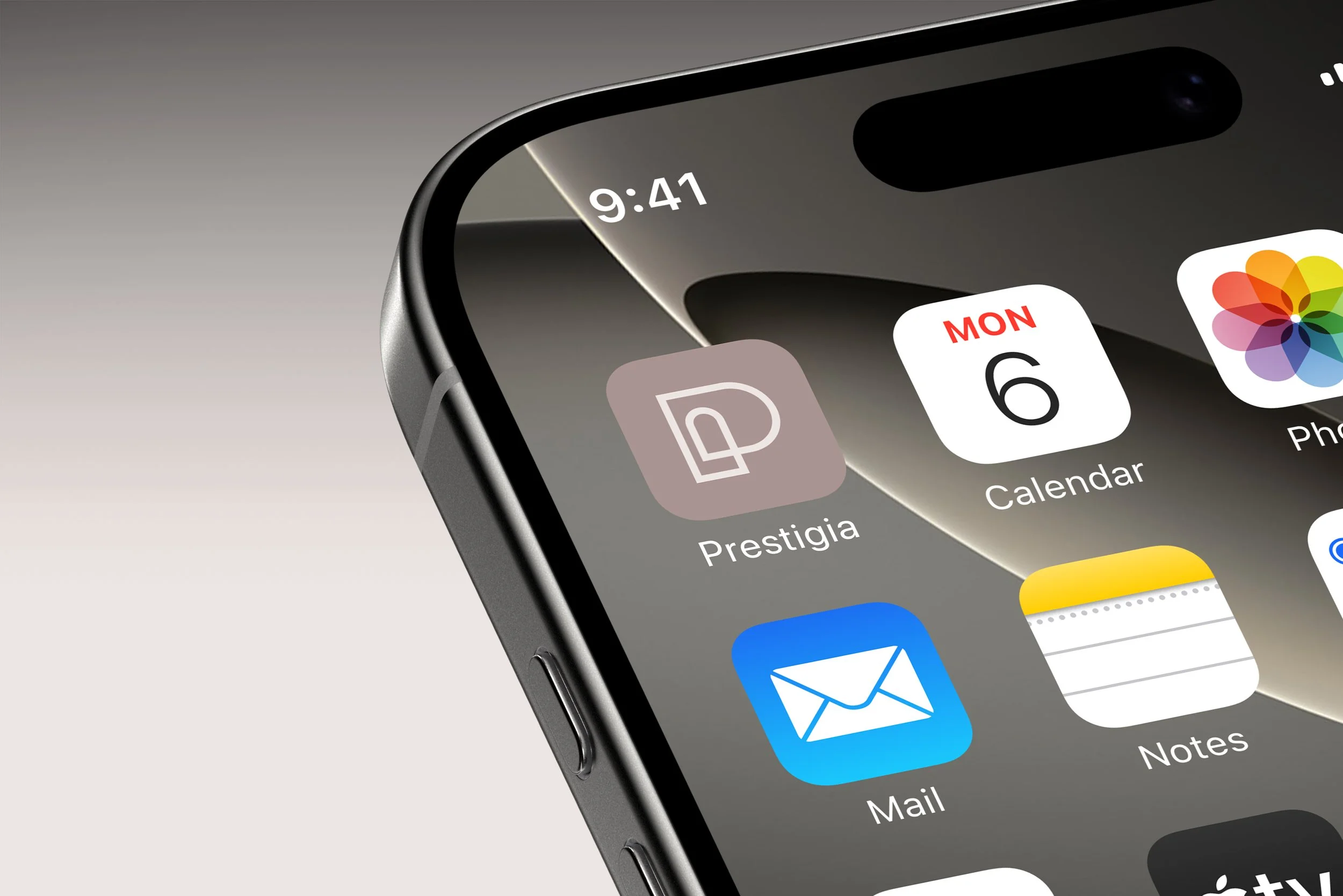 Close-up of an iPhone screen showing app icons including Prestigia, Calendar, Photos, Mail, and Notes, with the time 9:41 on the top left corner.