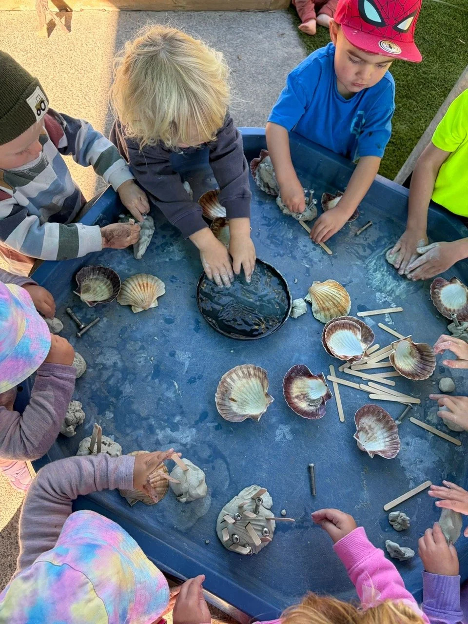 Children playing with loose parts and natural materials