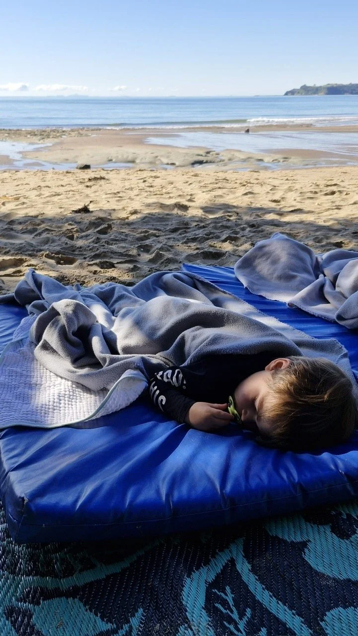 Toddler sleeping at the beach