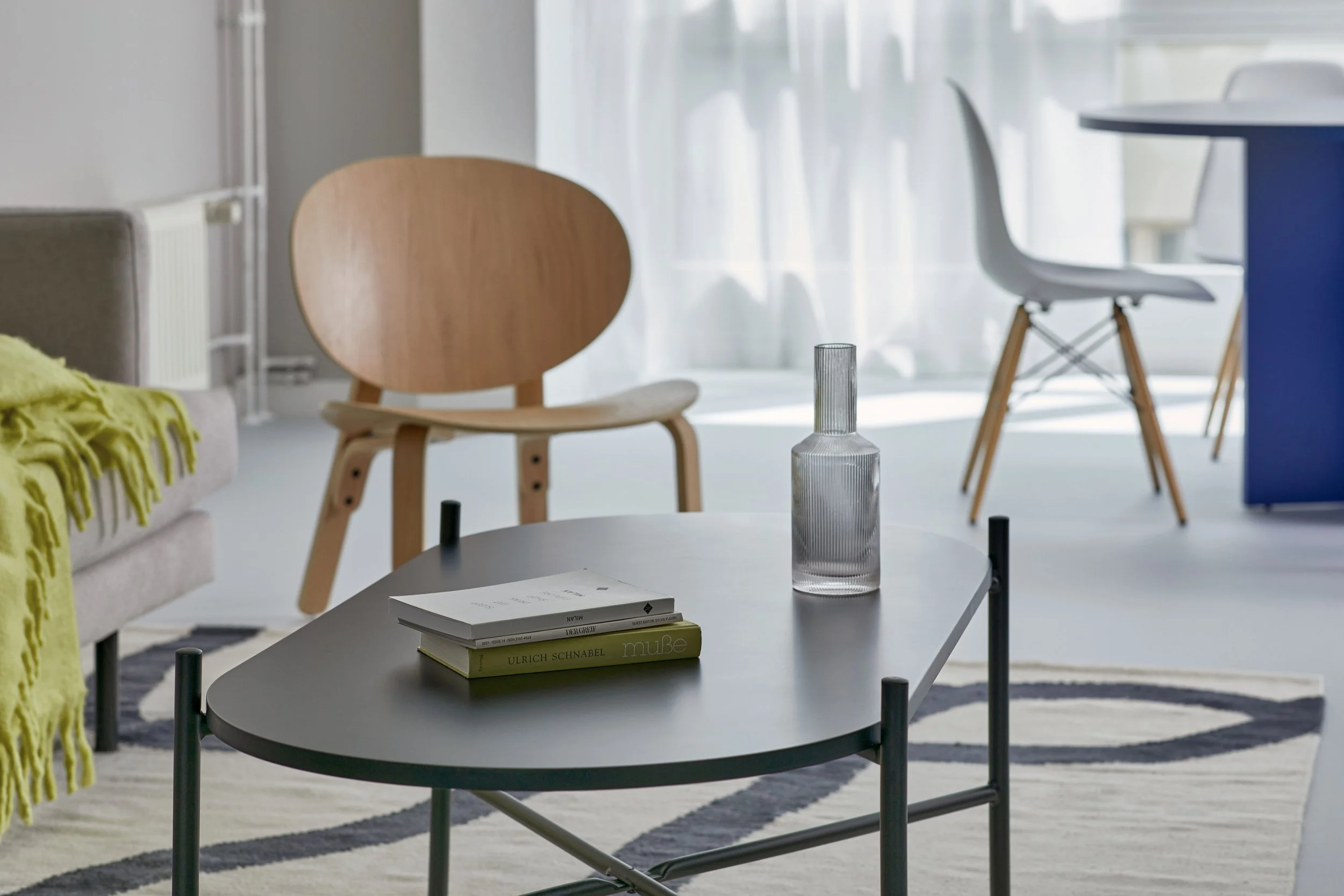 Minimal bedroom with wooden bed, blue curtains and neutral color palette, apartment in Berlin Mitte, interior design and styling by Steffi Bühlmaier, photography by Tobias Bärmann, 2024