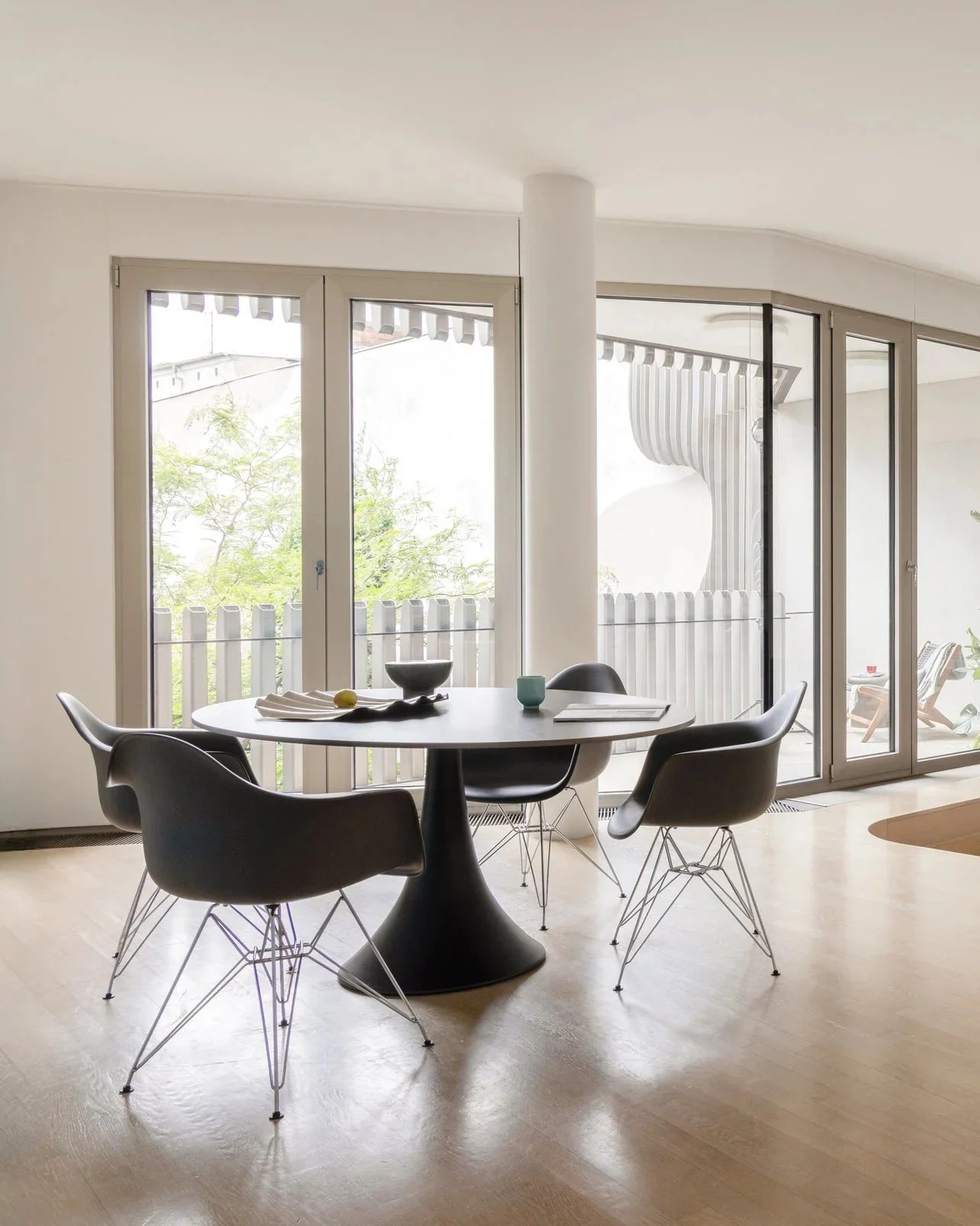 Open plan living and dining area with sectional sofa and glass pendant lights, apartment in Berlin Mitte, home staging and interior styling by Steffi Bühlmaier, photography by Jordana Schramm, 2025