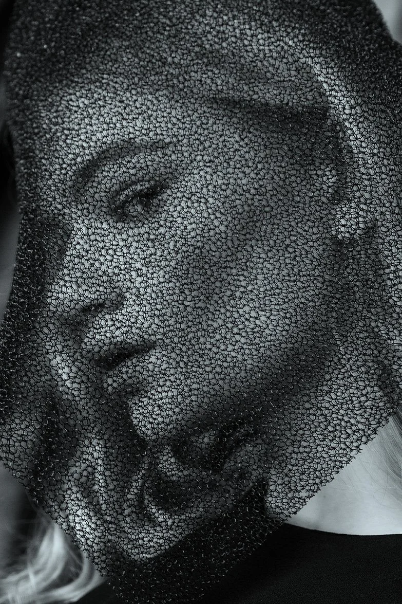 Editorial portrait featuring face veiled by textured mesh fabric creating soft distortion, set design and props styling by Steffi Bühlmaier, photography by Loreen Hinz for Vision Magazine China, 2019