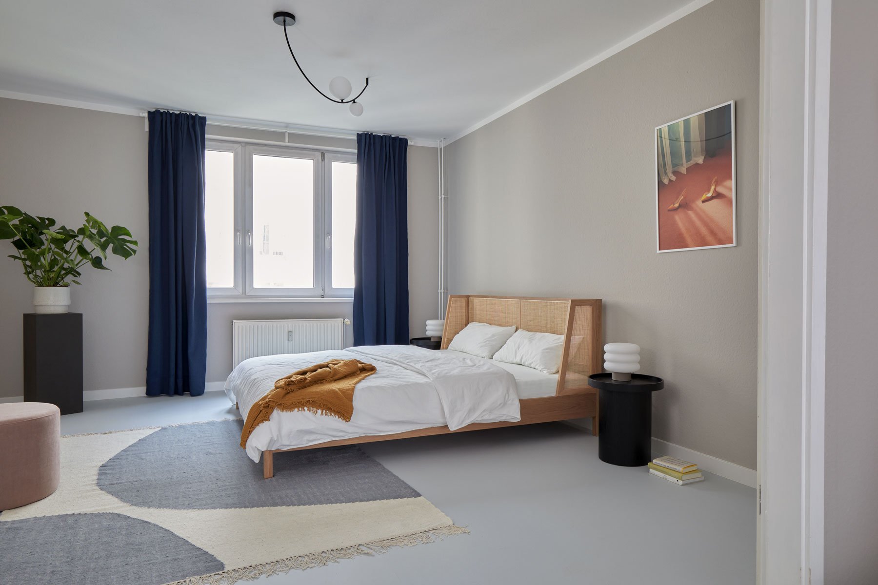 Living room detail with black coffee table, books and wooden lounge chair, apartment in Berlin Mitte, interior design and styling by Steffi Bühlmaier, photography by Tobias Bärmann, 2024